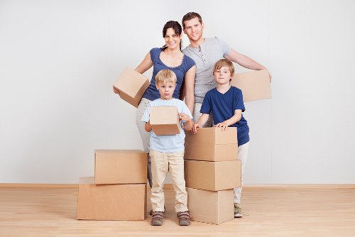 Experienced movers packing boxes with care in Swiss Cottage